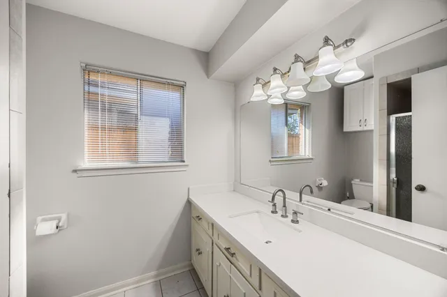 a bathroom with a sink vanity and a mirror