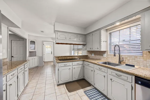 a kitchen with a sink stove and cabinets