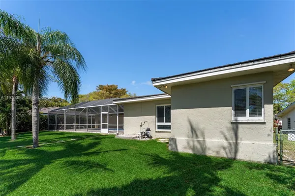 a view of a house with a backyard