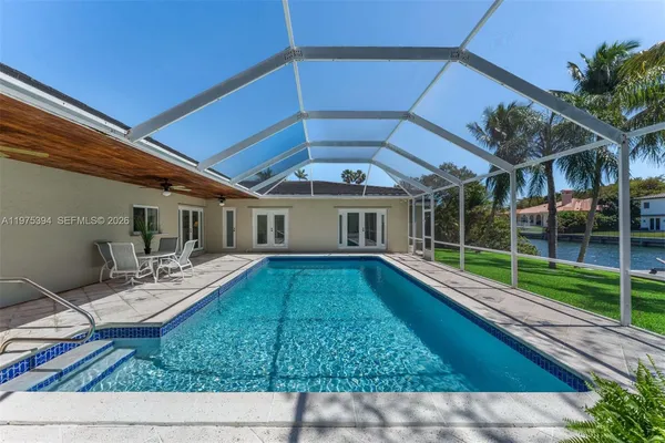 a view of a house with backyard porch and sitting area