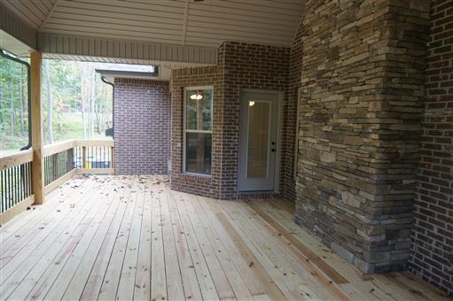 3 Old Clarksville Springfield Road Adams, TN 37010 - Photo 25 of 27 a view of a porch with wooden floor and a floor to ceiling window