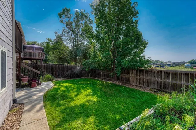 a view of a backyard with a small pool and sitting area