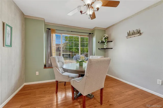a dining room with furniture a chandelier and wooden floor