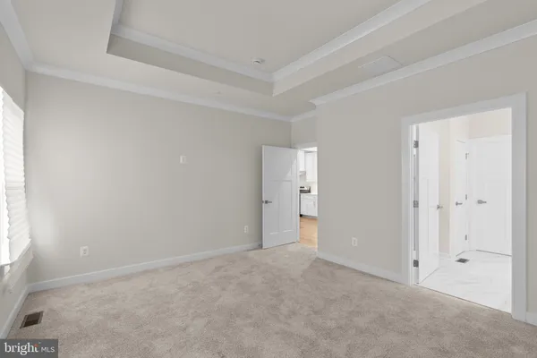 a view of an empty room and a window