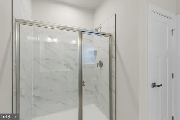a bathroom with a glass shower door