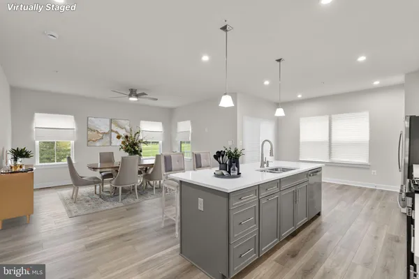 a kitchen with a sink and wooden floor