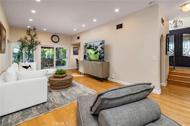 a dining room with furniture and wooden floor