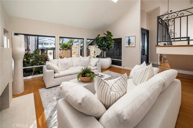 a living room with furniture and a potted plant