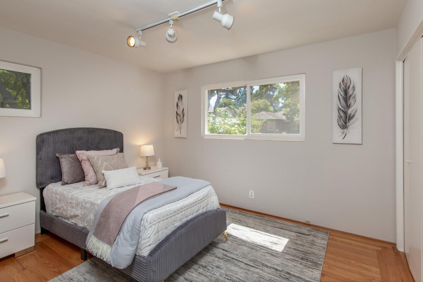 576 Bush Street Mountain View, CA 94041 - Photo 14 of 21 a bedroom with a bed and a painting on the wall