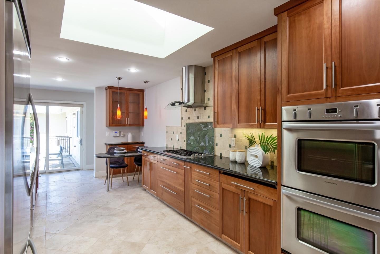 576 Bush Street Mountain View, CA 94041 - Photo 5 of 21 a kitchen with stainless steel appliances granite countertop wooden cabinets a stove top oven a sink and dishwasher