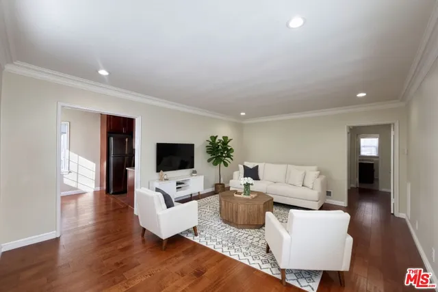 a living room with furniture flat screen tv and fireplace