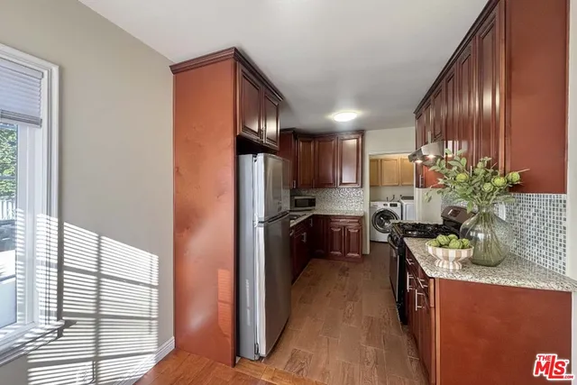 a kitchen with a refrigerator and a sink