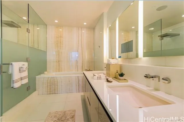 a bathroom with a tub sink and mirror