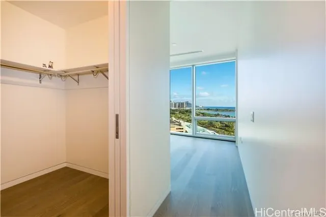 a view of a room with wooden floor and a window