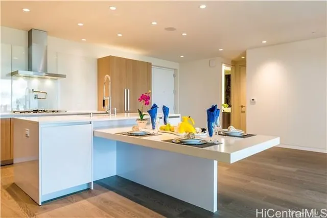 a kitchen with kitchen island granite countertop a sink and a stove