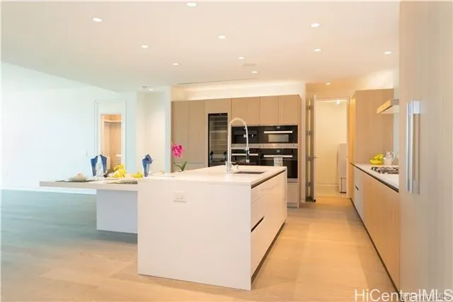 a kitchen with sink cabinets and stainless steel appliances