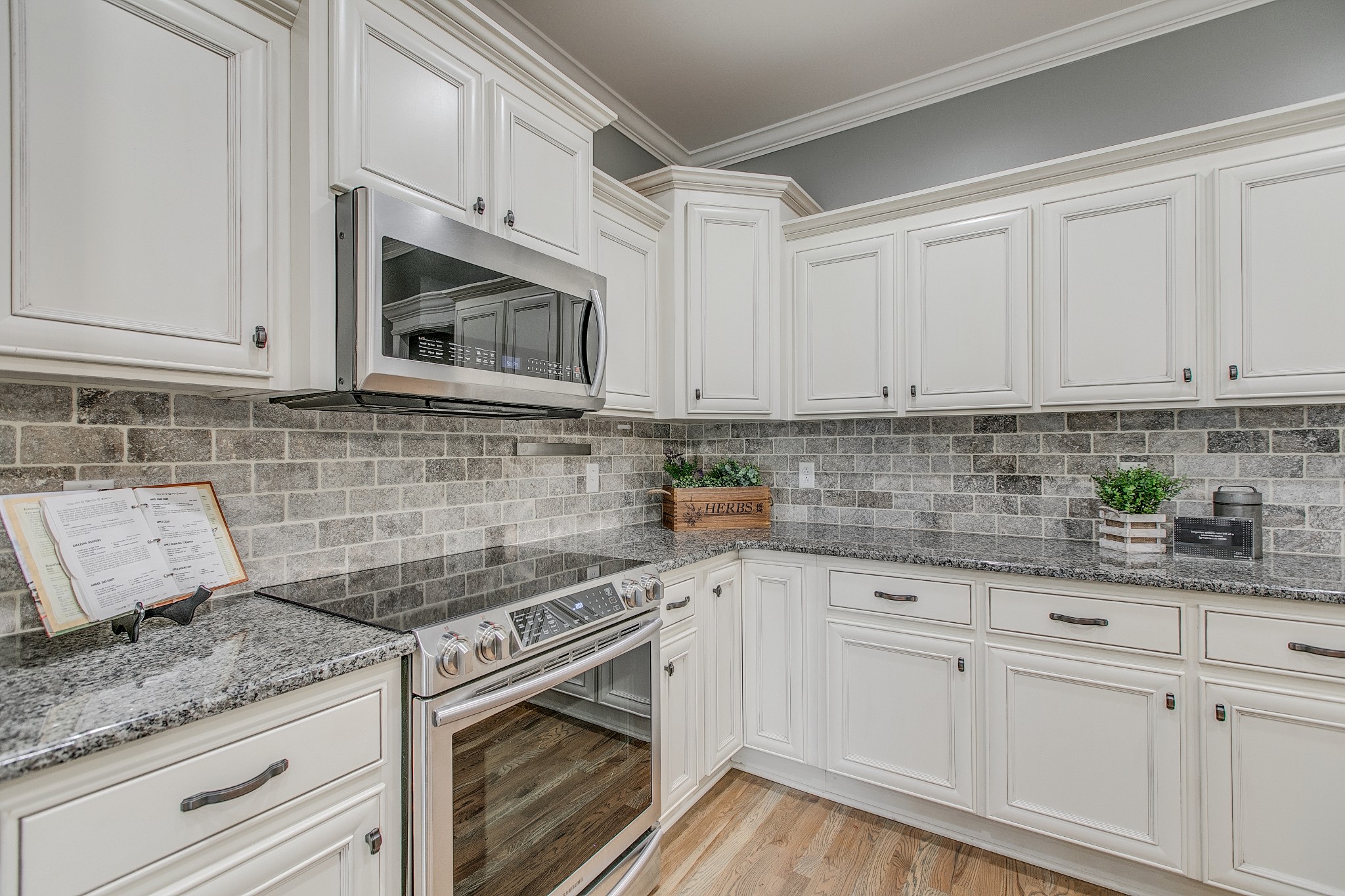 1102 Cascadeway Drive Murfreesboro, TN 37129 - Photo 16 of 45 a kitchen with granite countertop white cabinets and white appliances