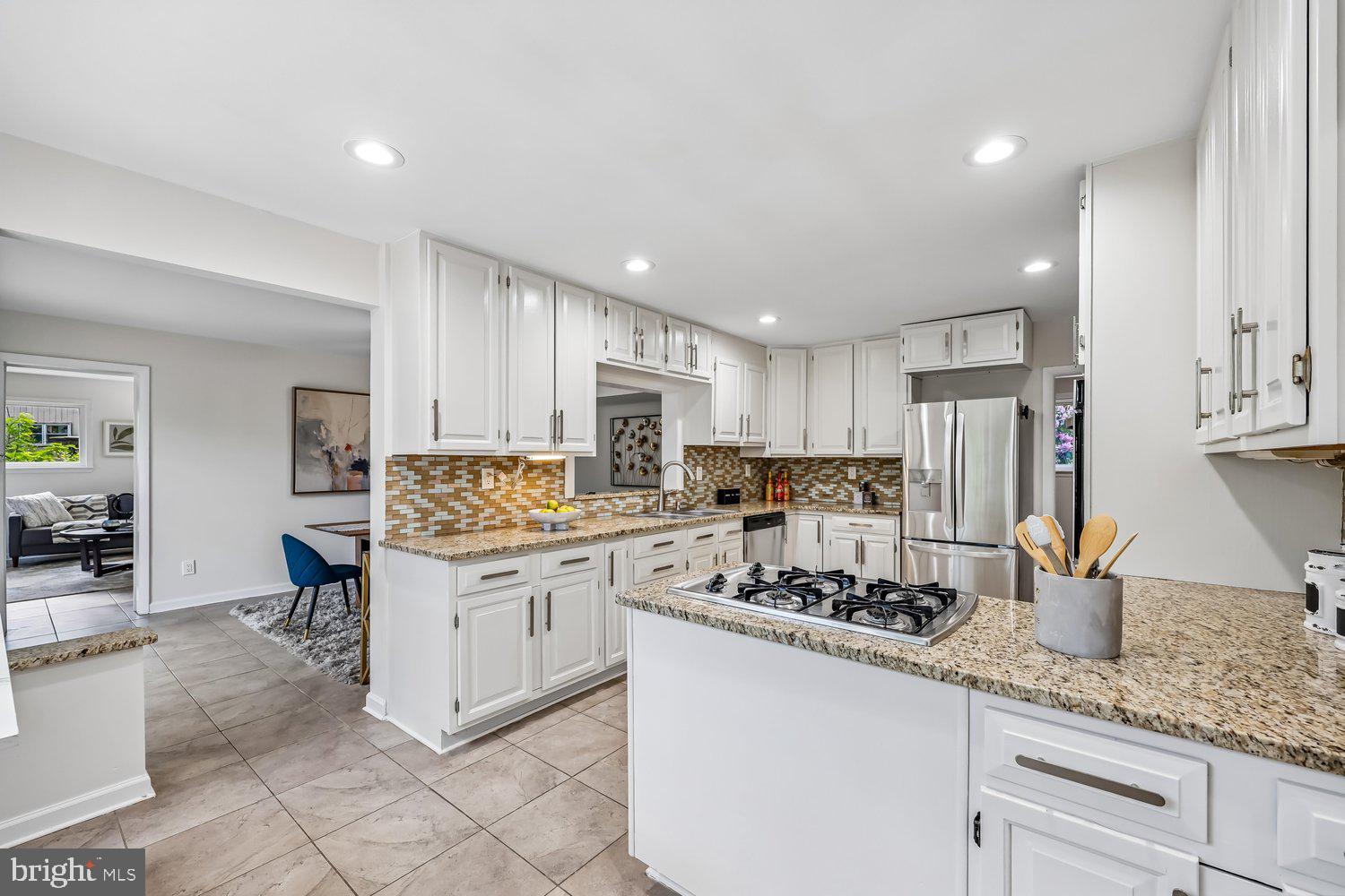 300 Gilsan Court Silver Spring, MD 20902 - Photo 43 of 117 a kitchen with stainless steel appliances granite countertop a sink stove and refrigerator