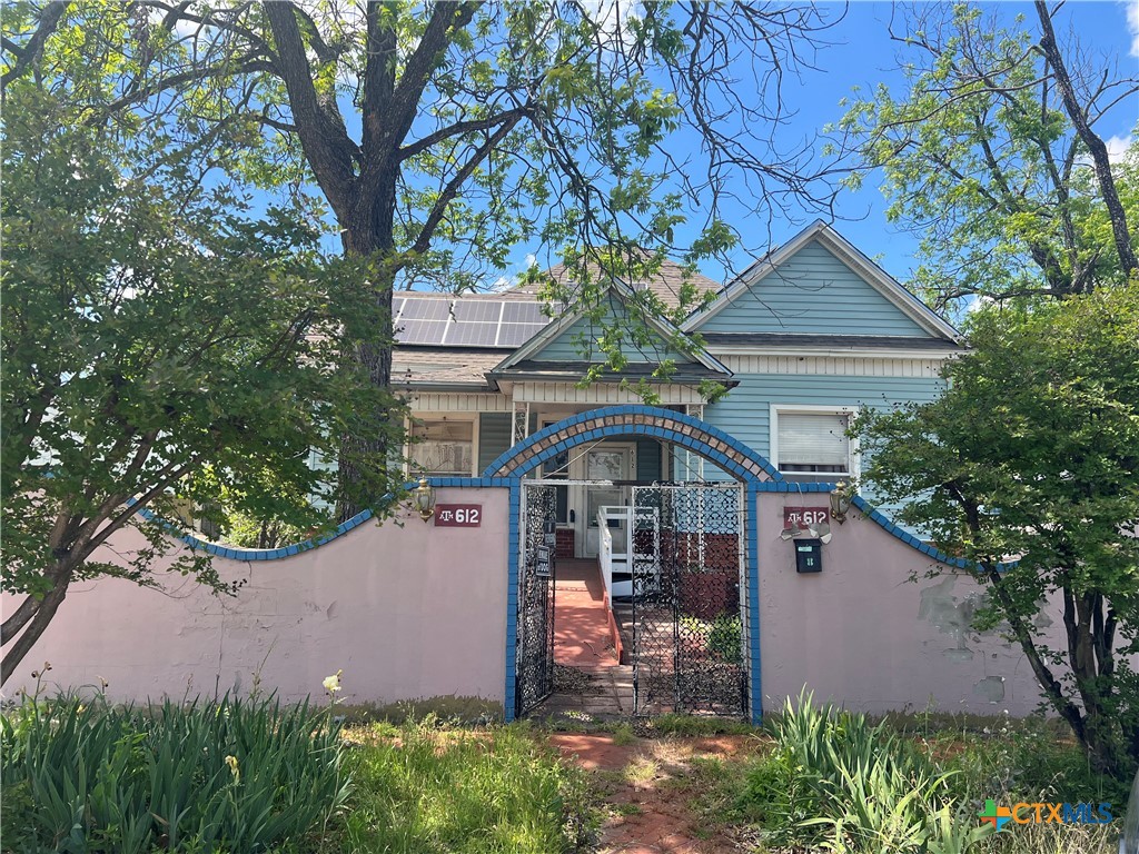 a front view of a house with garden