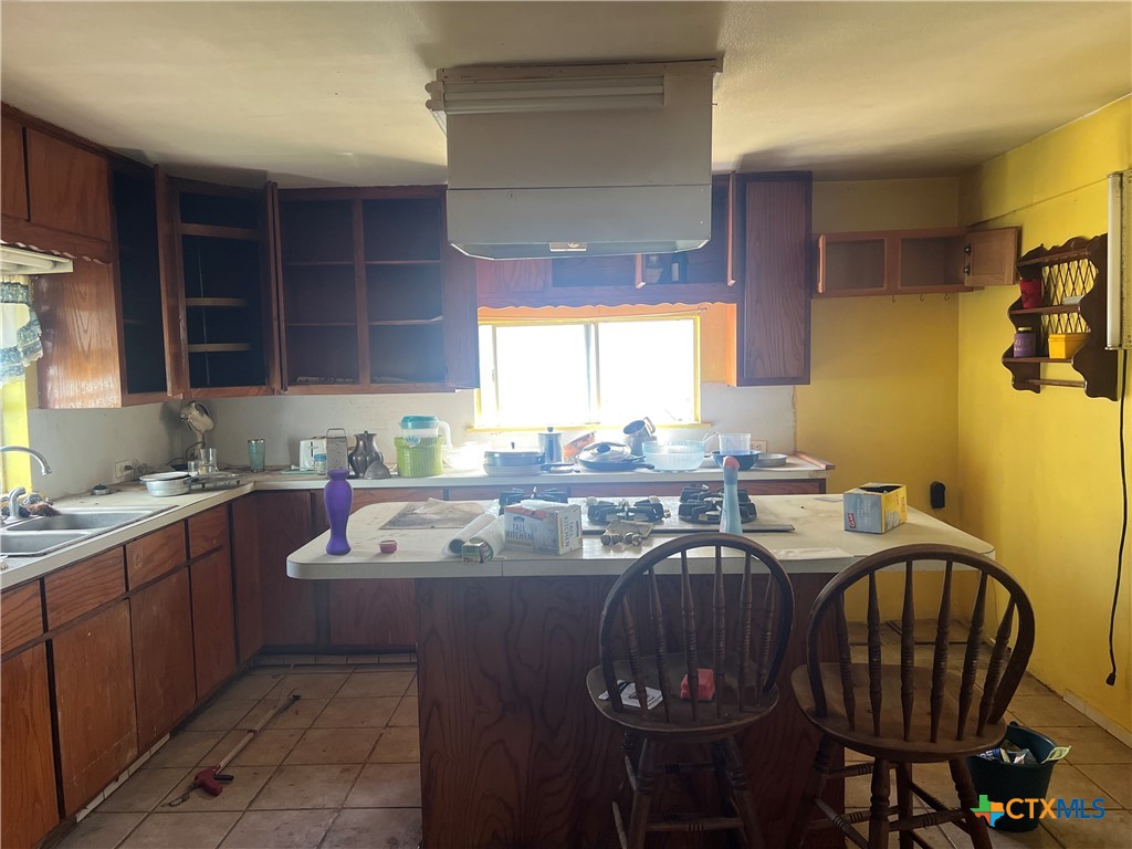 612 South 7th Street Temple, TX 76504 - Photo 27 of 43 a very nice looking kitchen with granite countertop a sink a stove a dining table and chairs