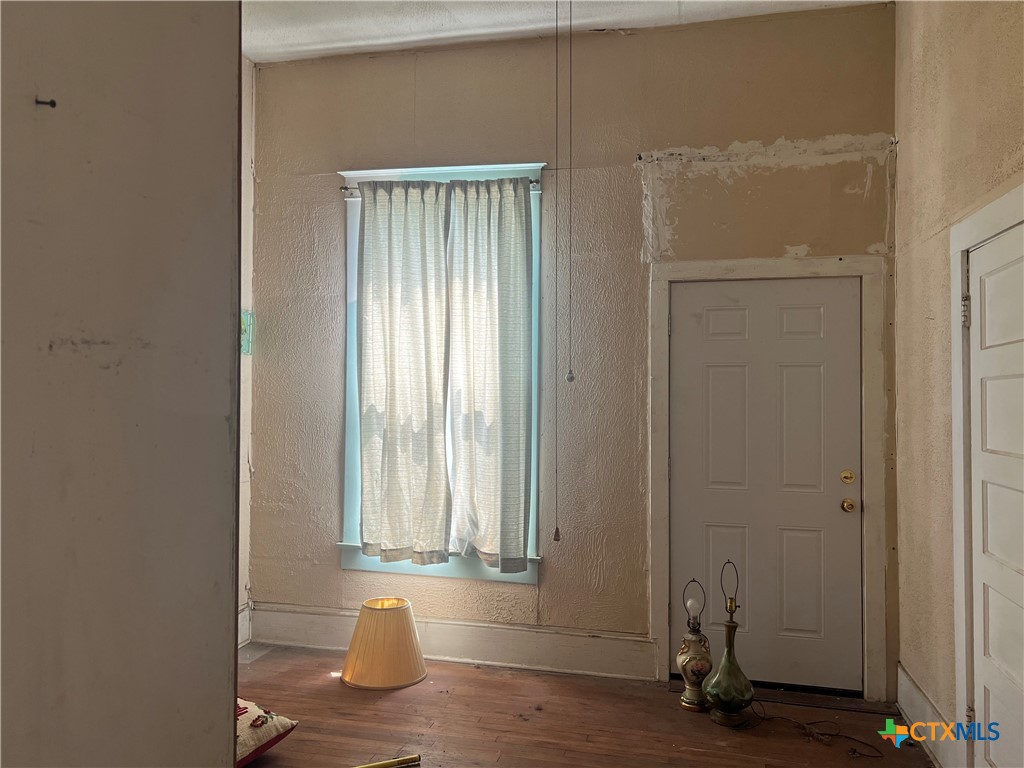 612 South 7th Street Temple, TX 76504 - Photo 5 of 43 an empty room with wooden floor and windows