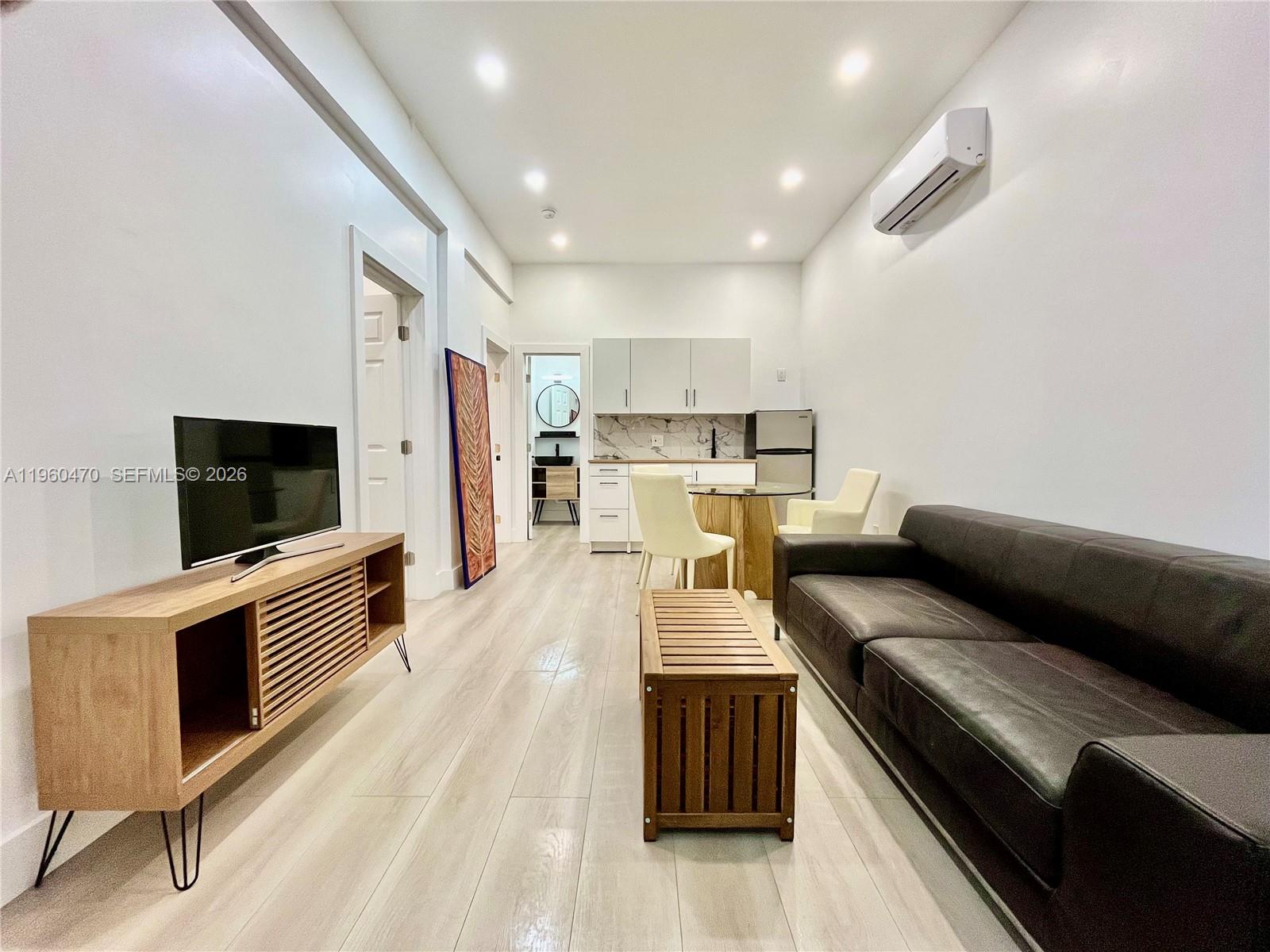 6241 Northwest Miami Place Miami, FL 33150 - Photo 1 of 33 a living room with furniture and a flat screen tv