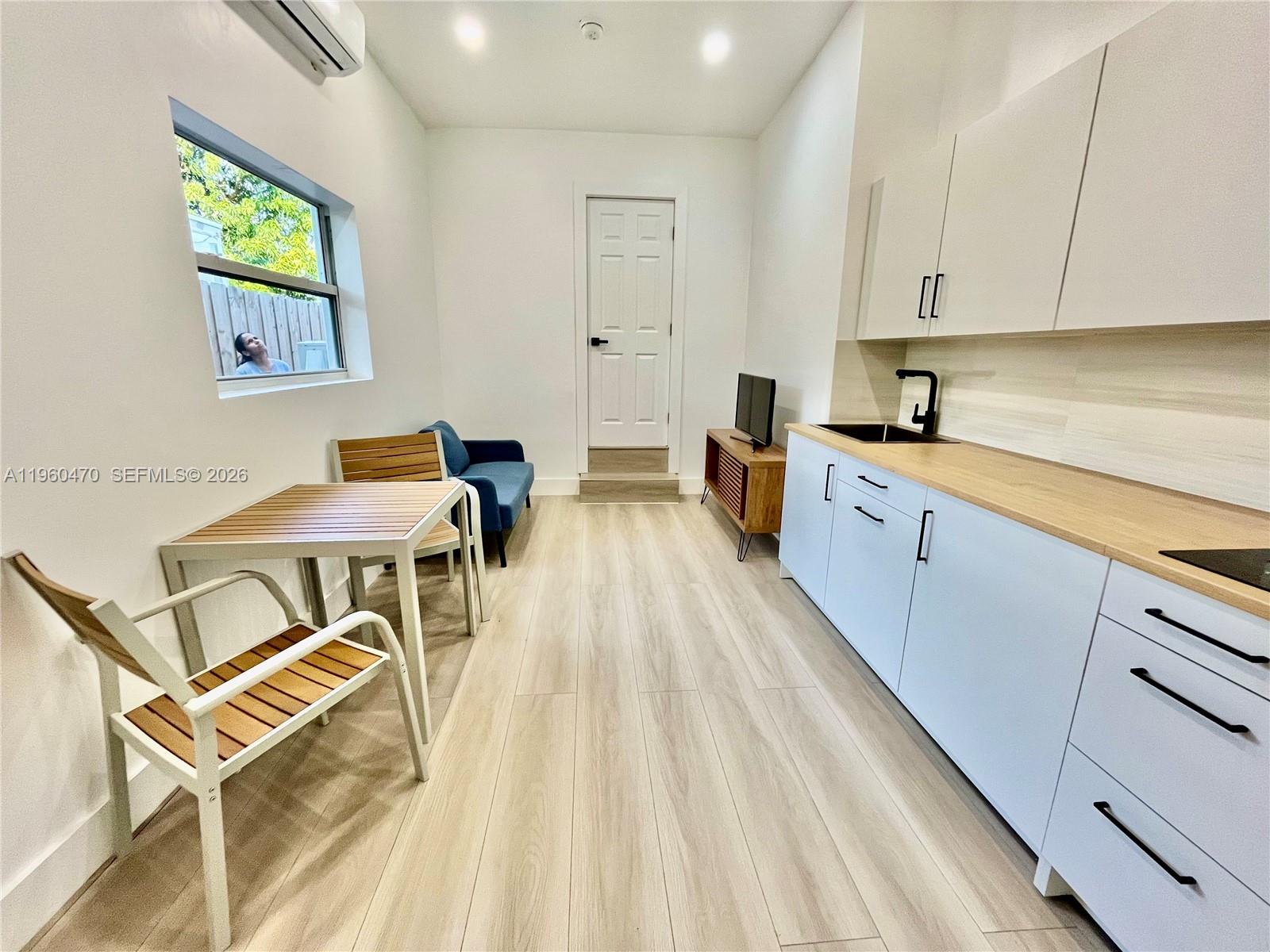 6241 Northwest Miami Place Miami, FL 33150 - Photo 13 of 33 a kitchen with a sink and cabinets