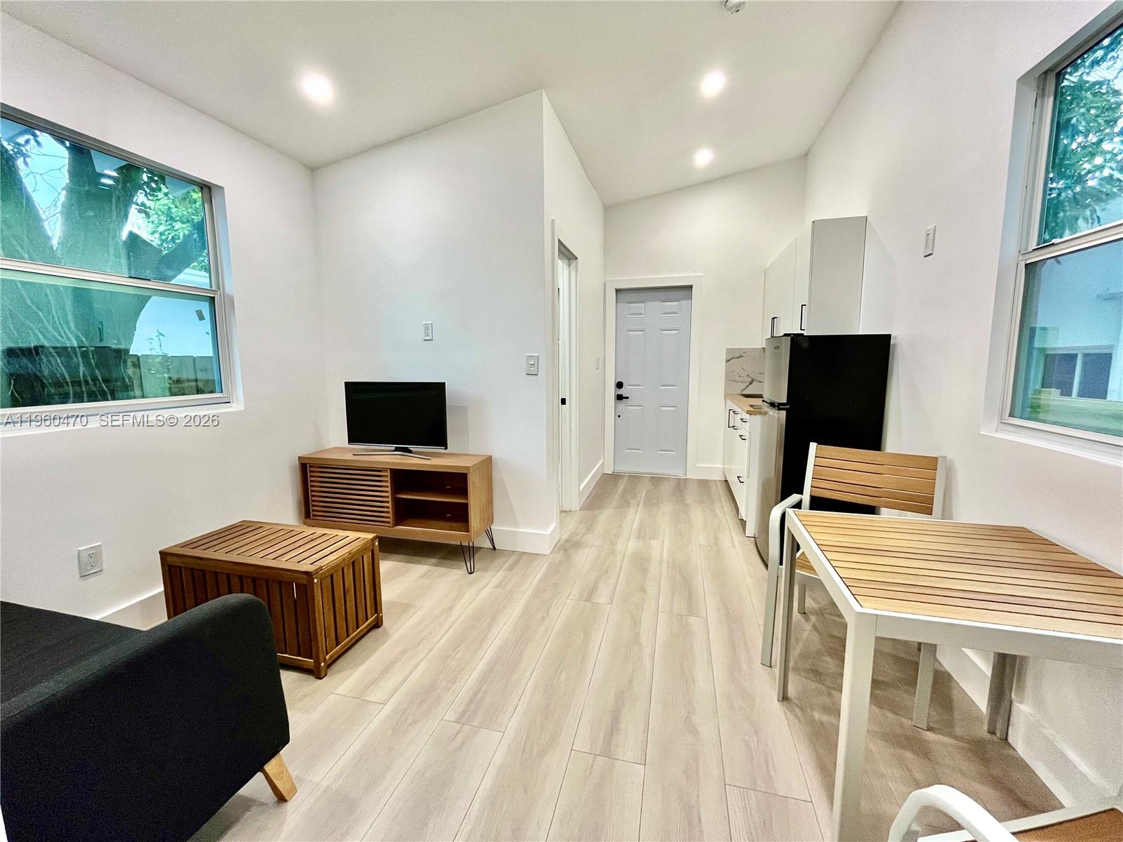 6241 Northwest Miami Place Miami, FL 33150 - Photo 19 of 33 a living room with furniture and a flat screen tv