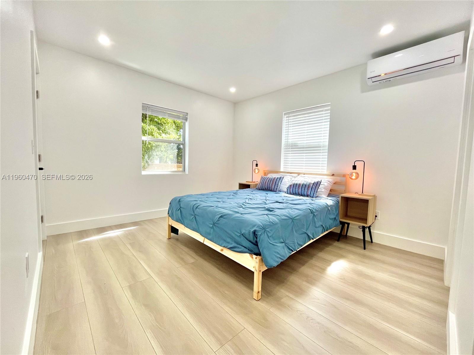 6241 Northwest Miami Place Miami, FL 33150 - Photo 2 of 33 a bedroom with a bed and a window