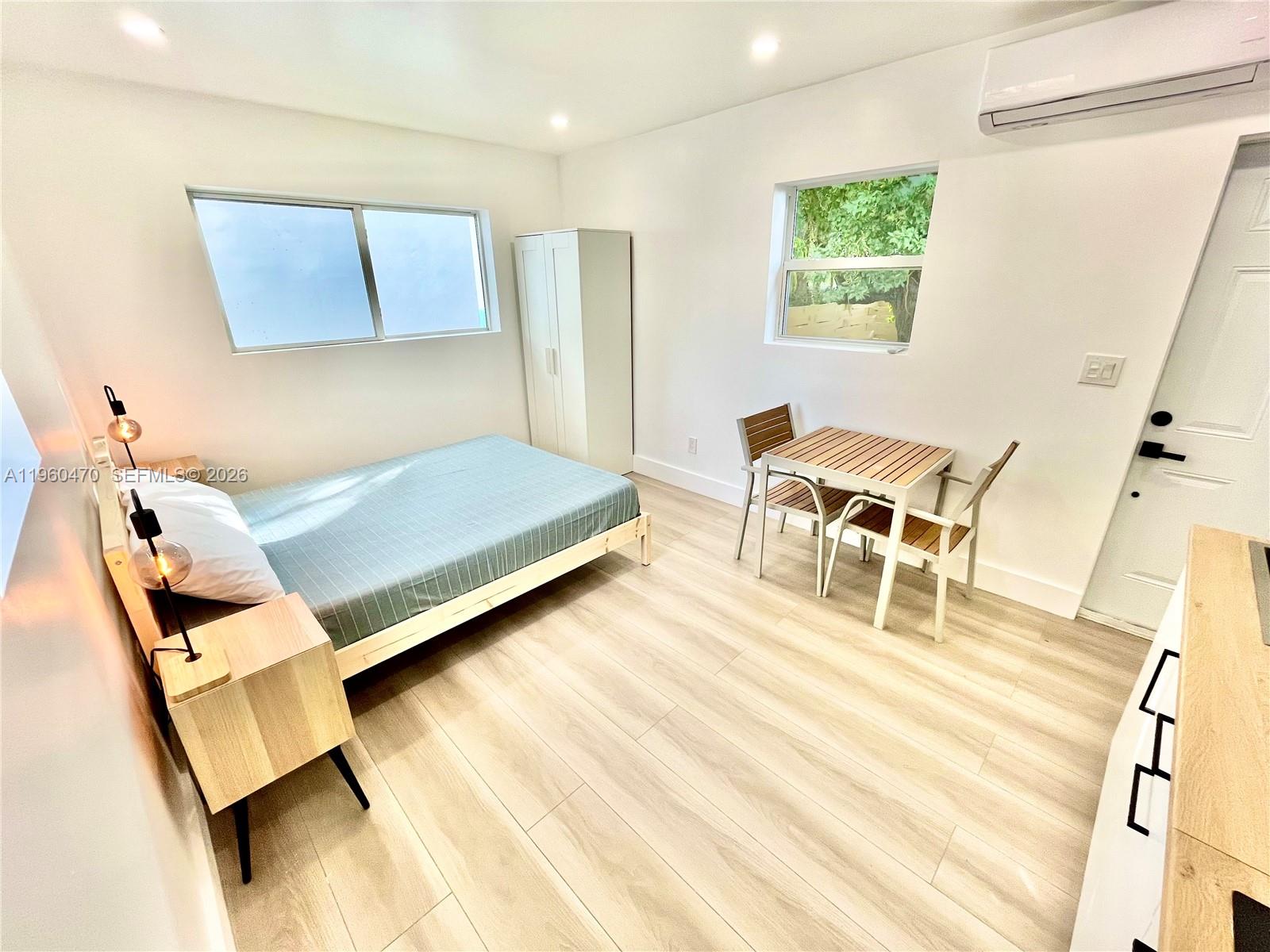 6241 Northwest Miami Place Miami, FL 33150 - Photo 22 of 33 a living room with a bed furniture and a window