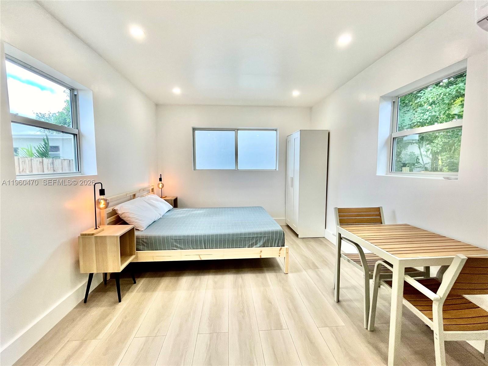 6241 Northwest Miami Place Miami, FL 33150 - Photo 24 of 33 a bedroom with a bed and a table