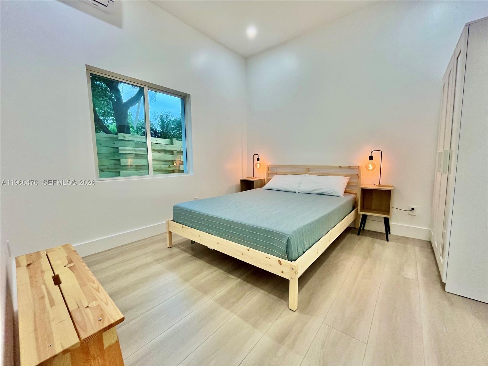 6241 Northwest Miami Place Miami, FL 33150 - Photo 27 of 33 a bedroom with a bed and window