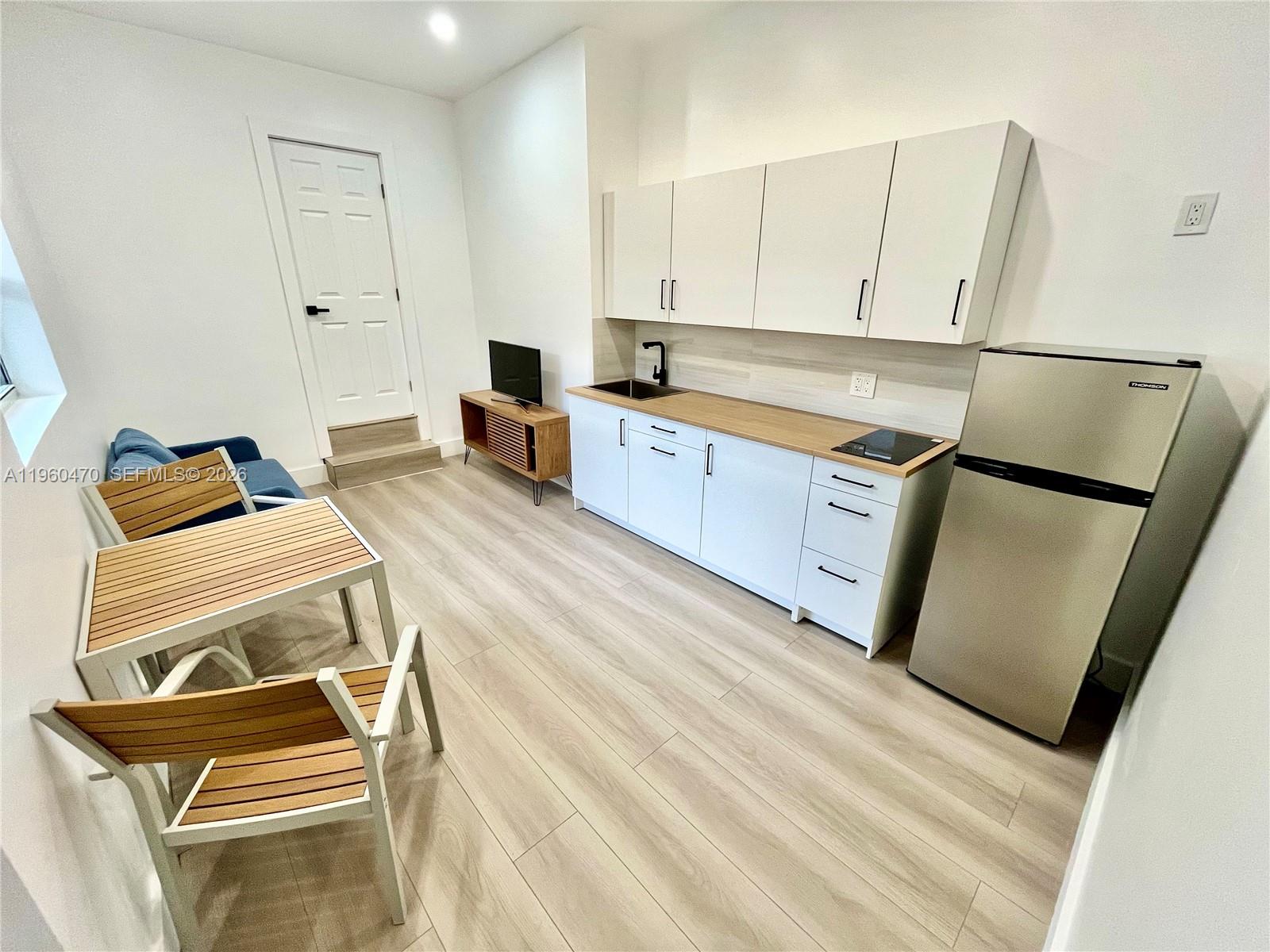 6241 Northwest Miami Place Miami, FL 33150 - Photo 28 of 33 a bedroom with a bed and a utility room