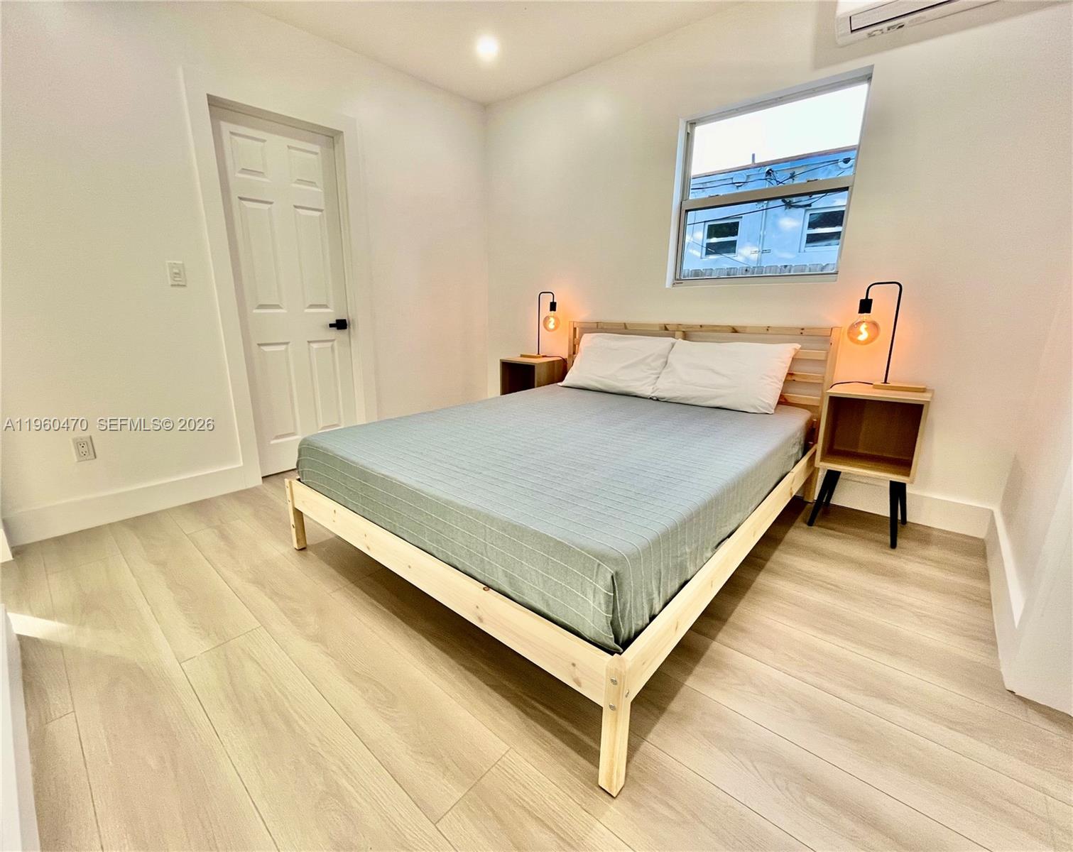 6241 Northwest Miami Place Miami, FL 33150 - Photo 31 of 33 a bedroom with a bed and a table in it