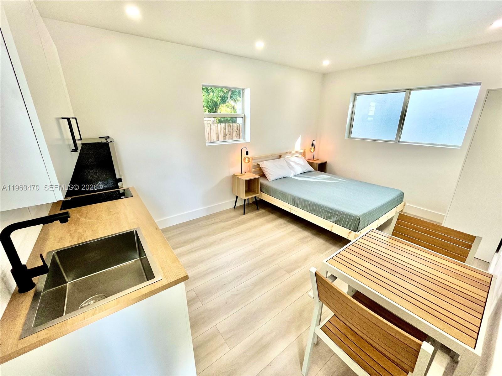 6241 Northwest Miami Place Miami, FL 33150 - Photo 32 of 33 a view of a room with wooden floor and windows