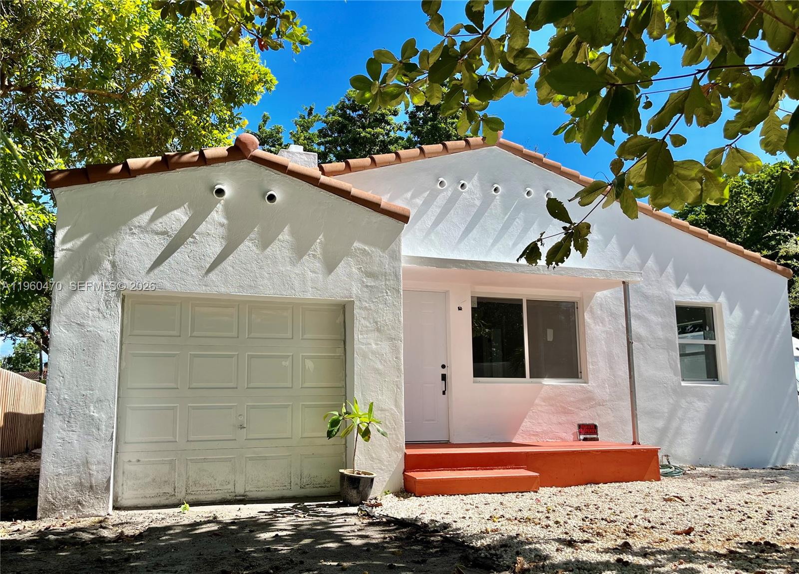 6241 Northwest Miami Place Miami, FL 33150 - Photo 6 of 33 a front view of a house with a yard