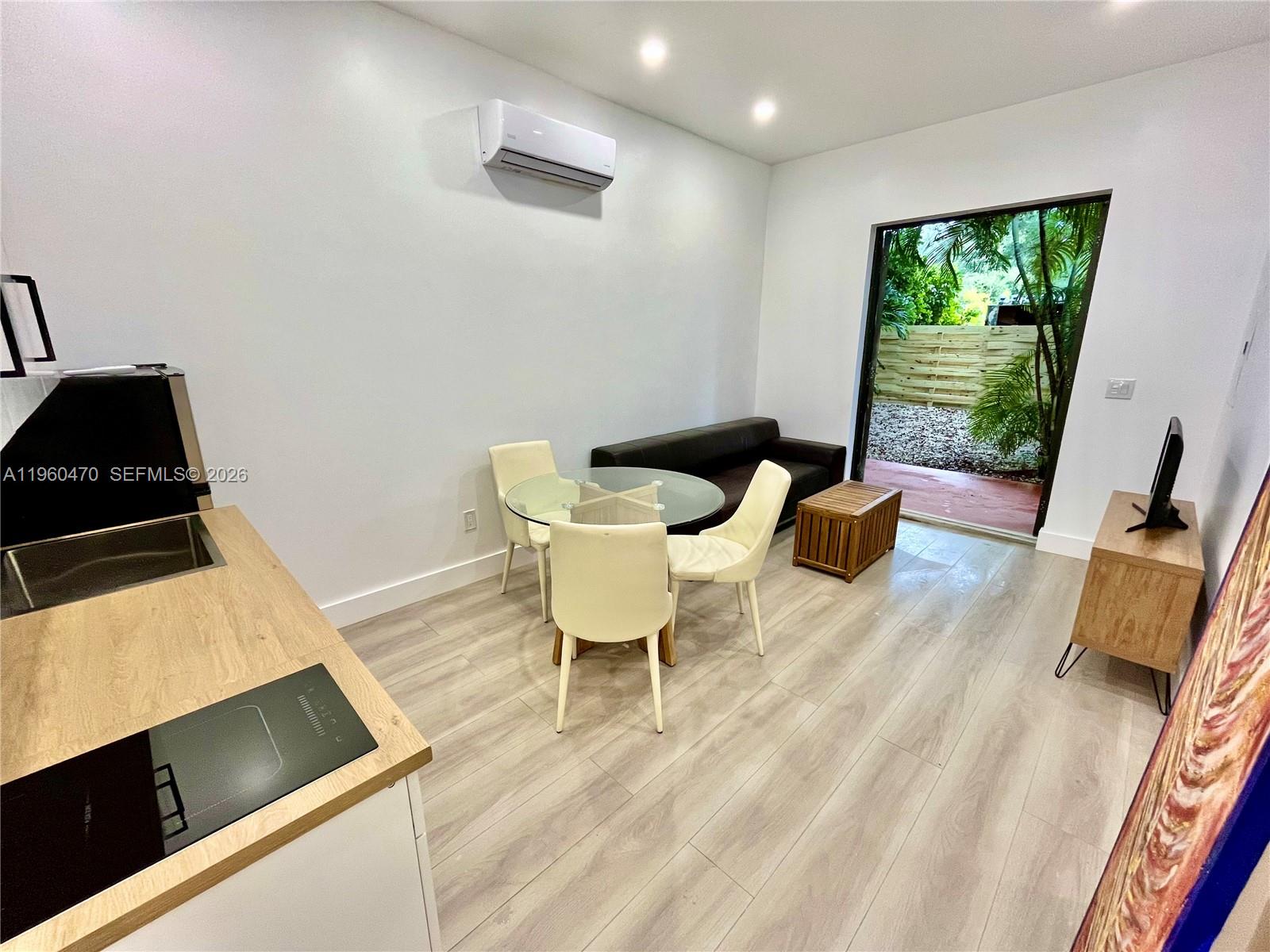 6241 Northwest Miami Place Miami, FL 33150 - Photo 7 of 33 a living room with furniture and a window