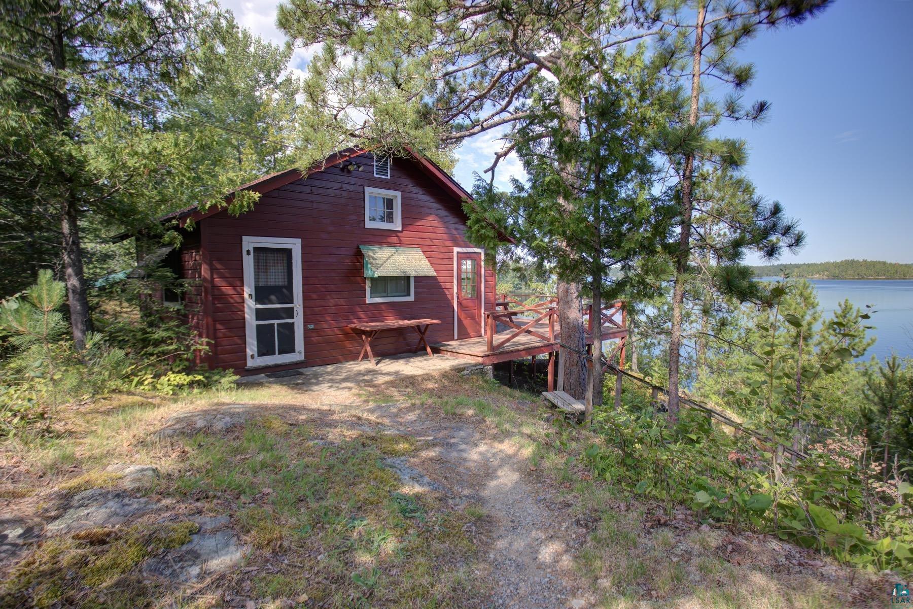 2815 Schaeffer Road Ely, MN 55731 - Photo 18 of 37 Red-sided structure with a white screen door and multiple windows
