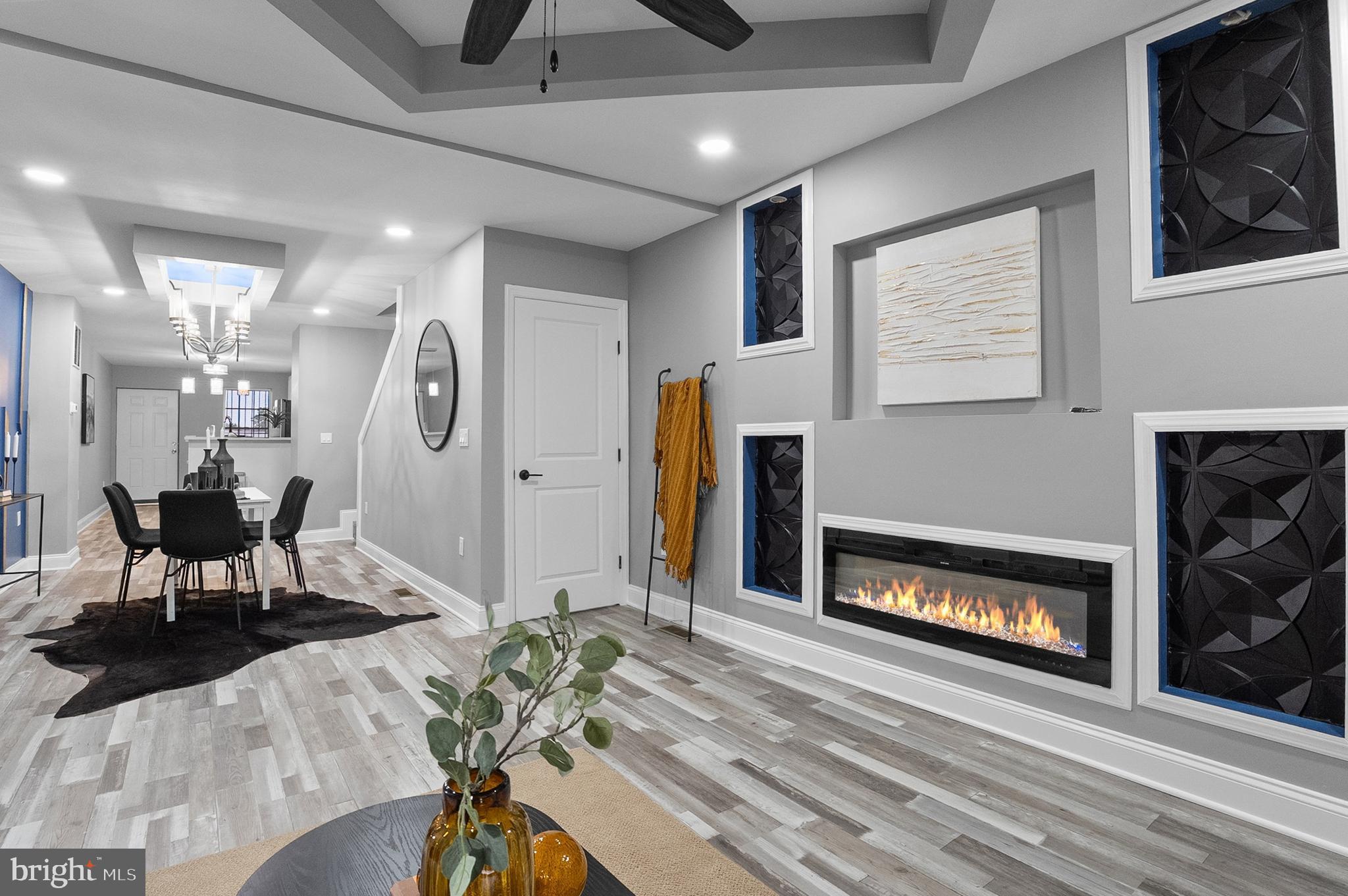 1201 North Fulton Avenue Baltimore, MD 21217 - Photo 11 of 36 a living room with furniture a flat screen tv and a fireplace