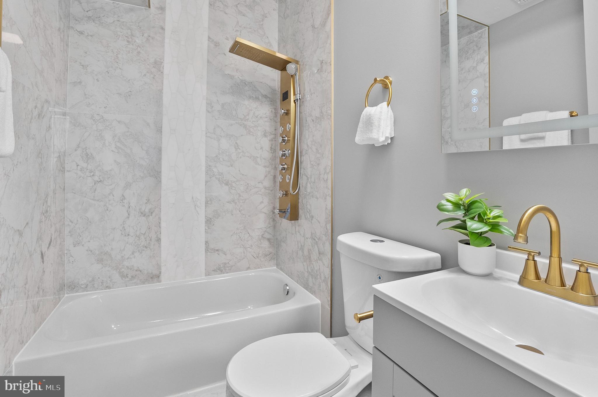 1201 North Fulton Avenue Baltimore, MD 21217 - Photo 19 of 36 a bathroom with a sink a toilet and bathtub