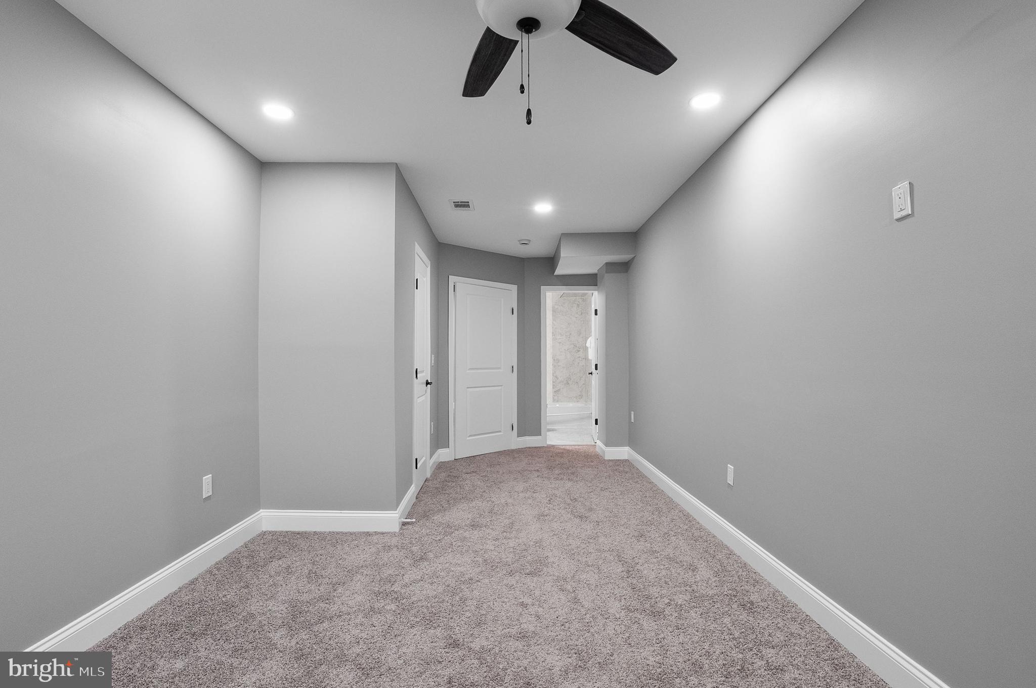 1201 North Fulton Avenue Baltimore, MD 21217 - Photo 21 of 36 an empty room with a ceiling fan and carpet