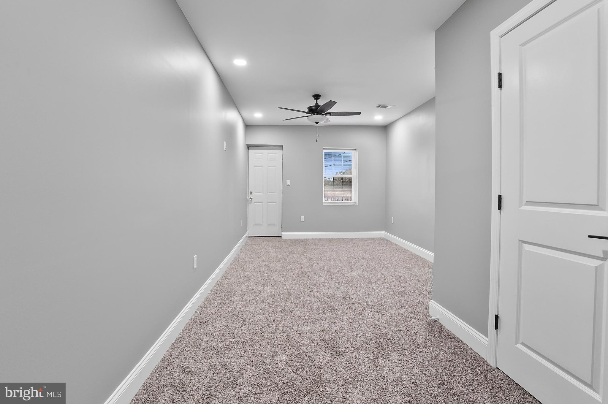 1201 North Fulton Avenue Baltimore, MD 21217 - Photo 22 of 36 wooden floor in an empty room with a window