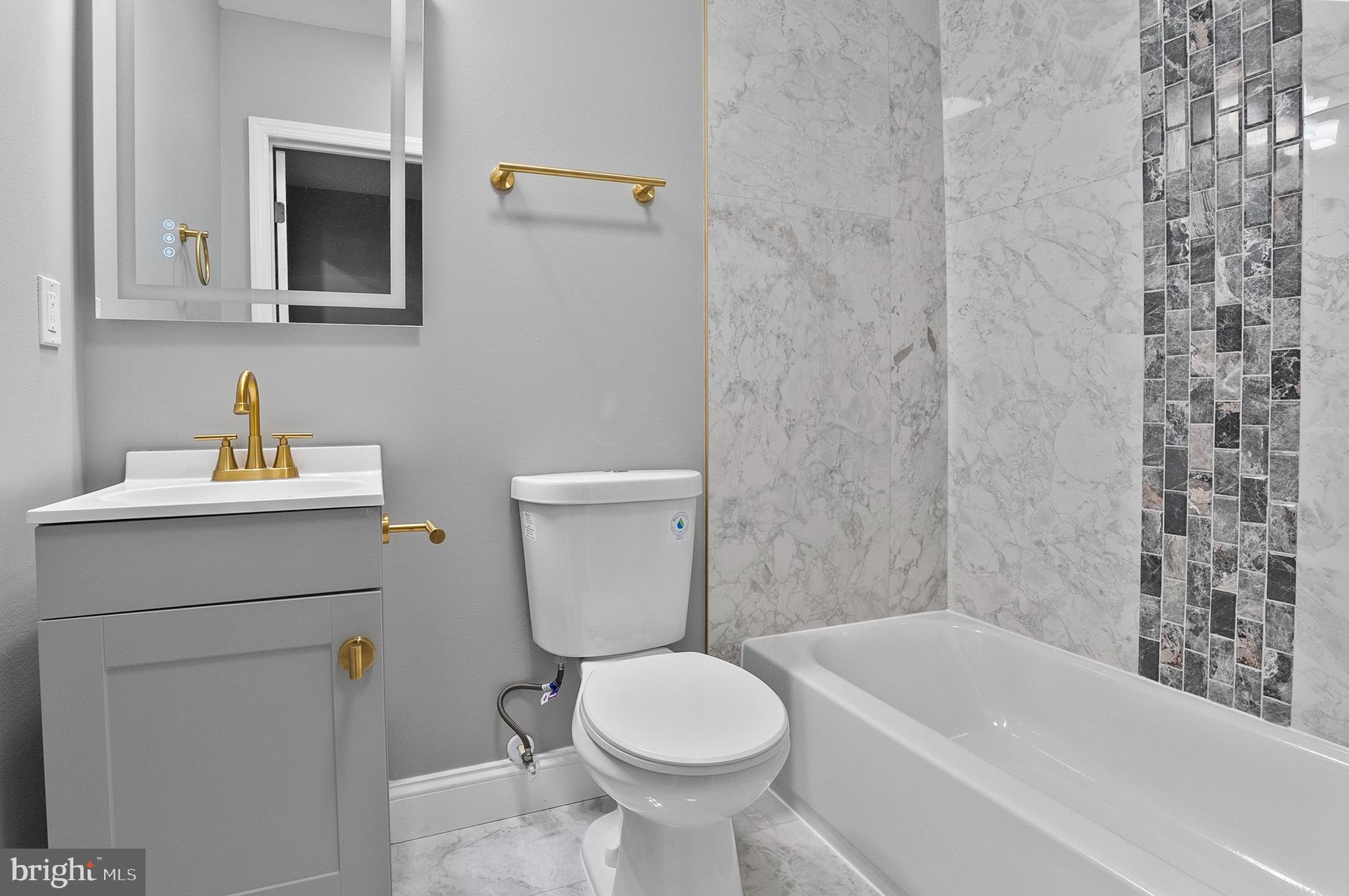 1201 North Fulton Avenue Baltimore, MD 21217 - Photo 27 of 36 a bathroom with a sink toilet and bathtub