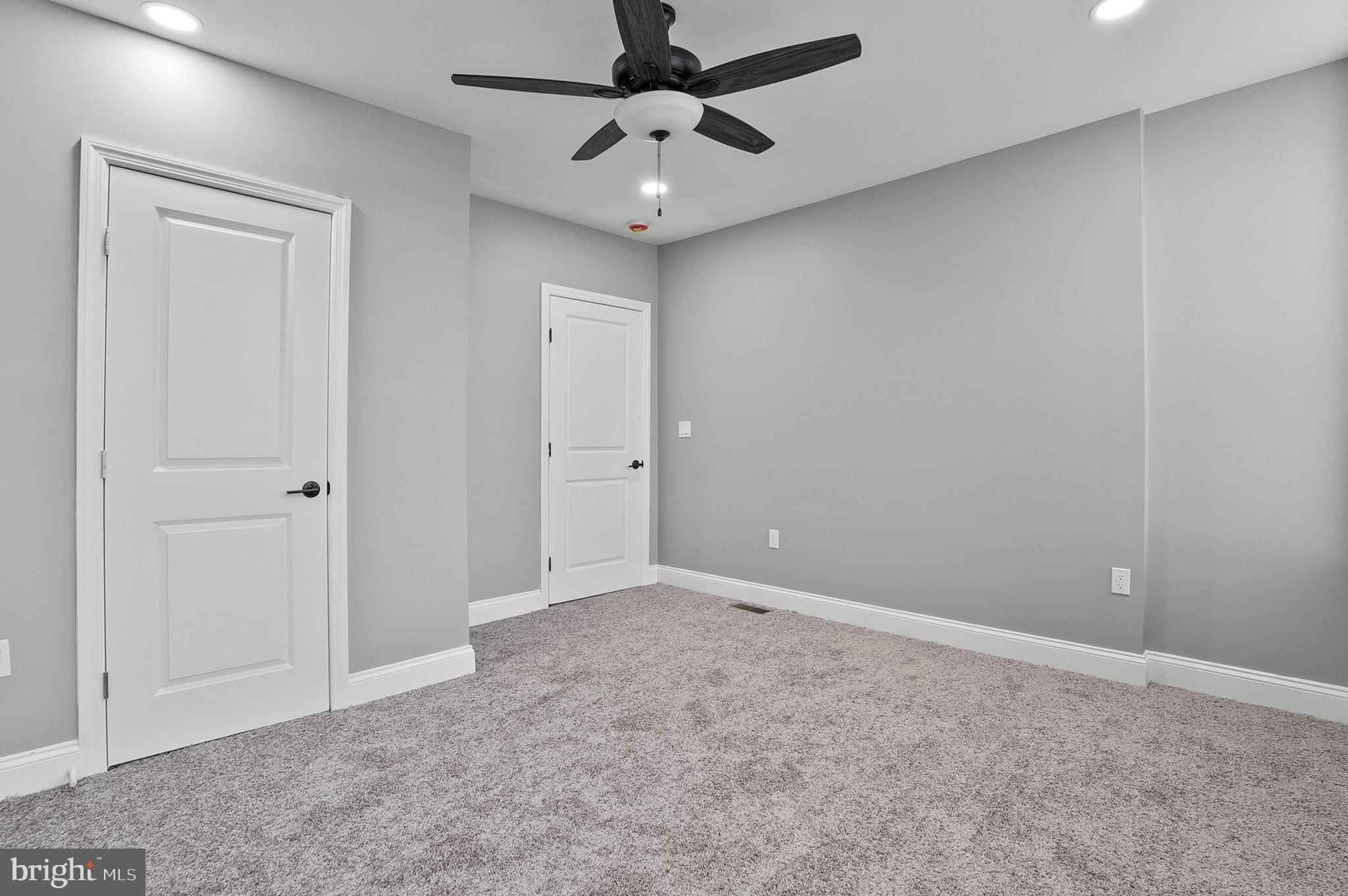 1201 North Fulton Avenue Baltimore, MD 21217 - Photo 28 of 36 an empty room with a ceiling fan and a window