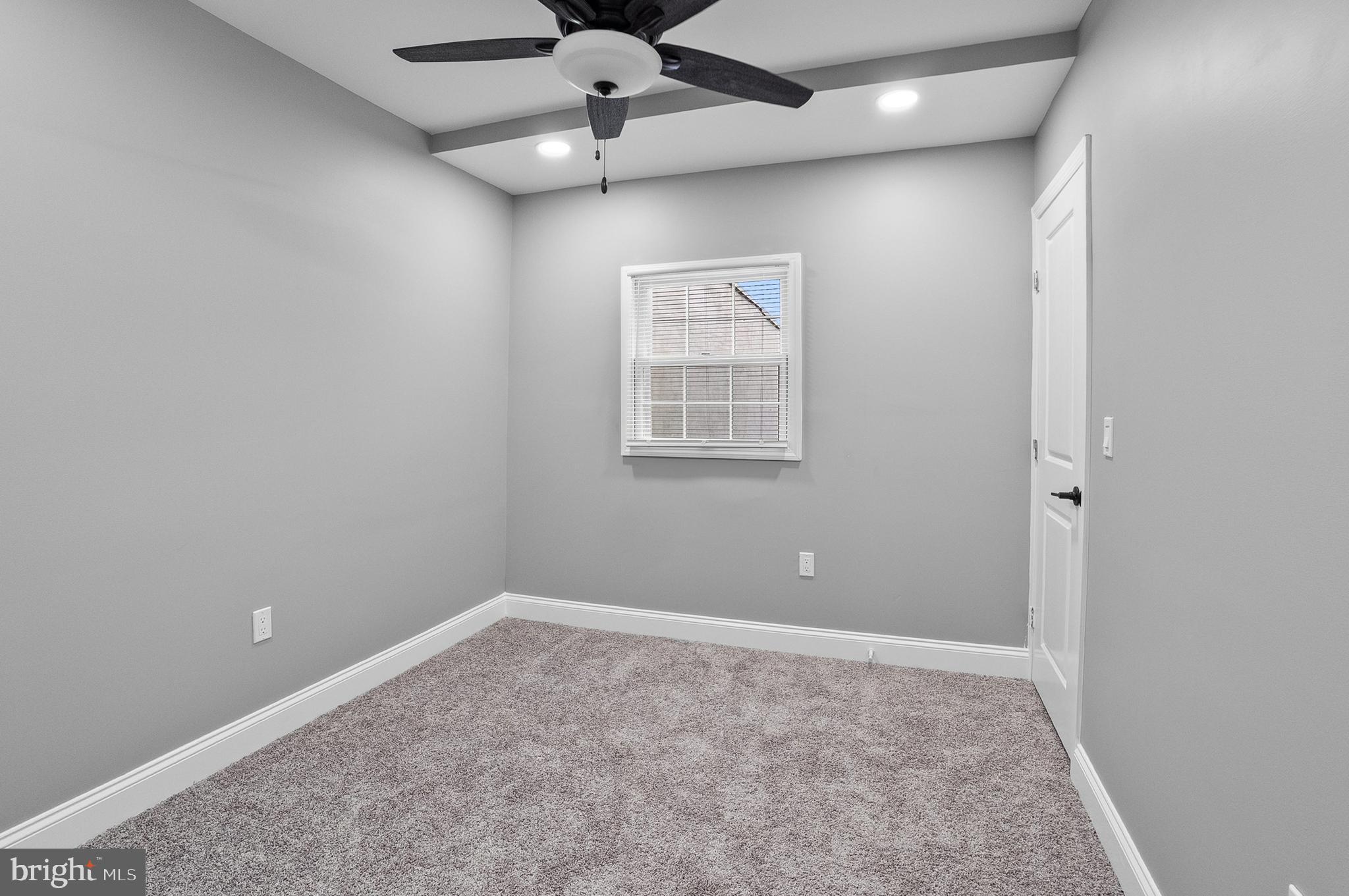 1201 North Fulton Avenue Baltimore, MD 21217 - Photo 29 of 36 an empty room with a ceiling fan and a window