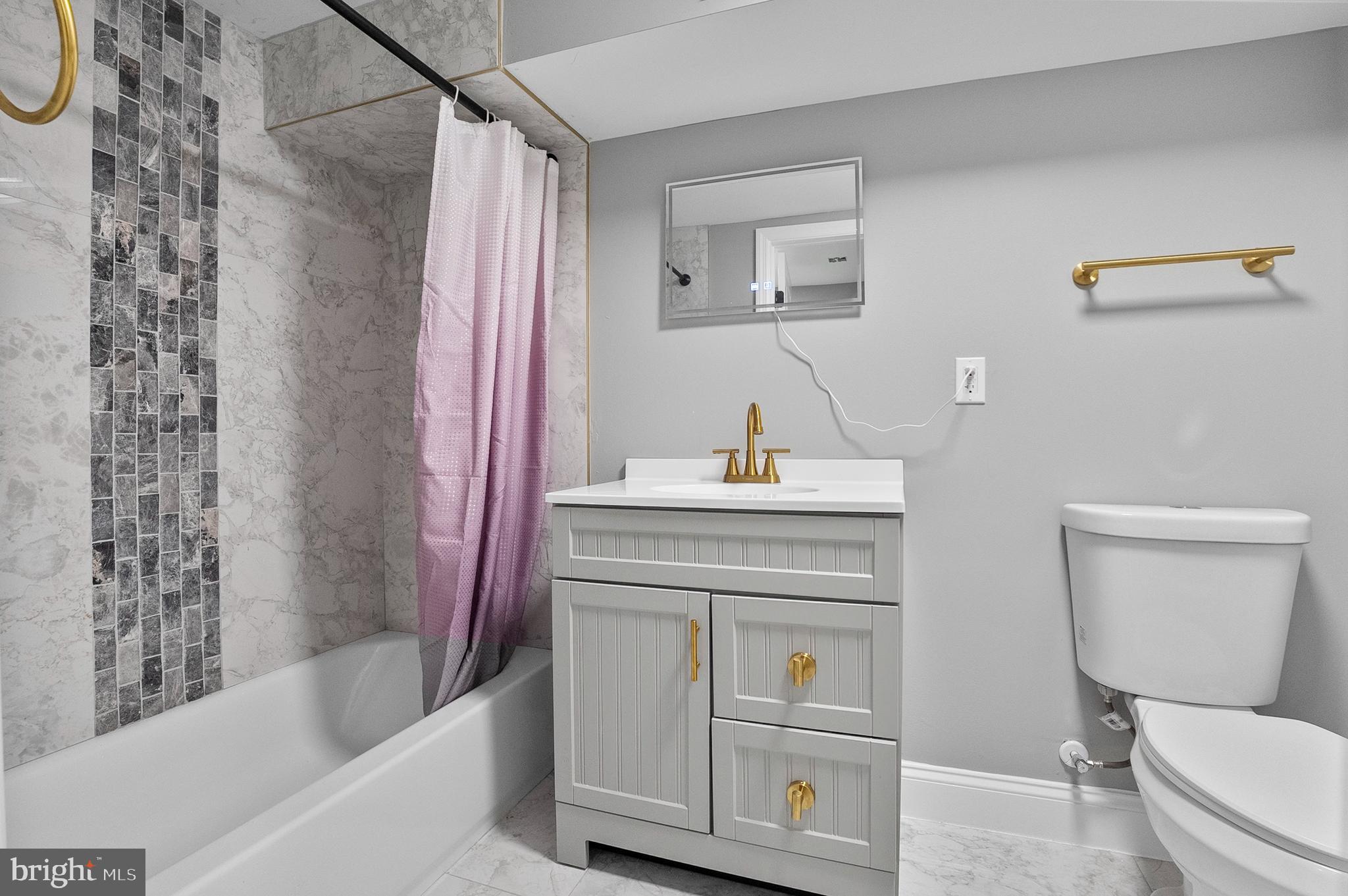 1201 North Fulton Avenue Baltimore, MD 21217 - Photo 31 of 36 a bathroom with a sink toilet vanity and tub