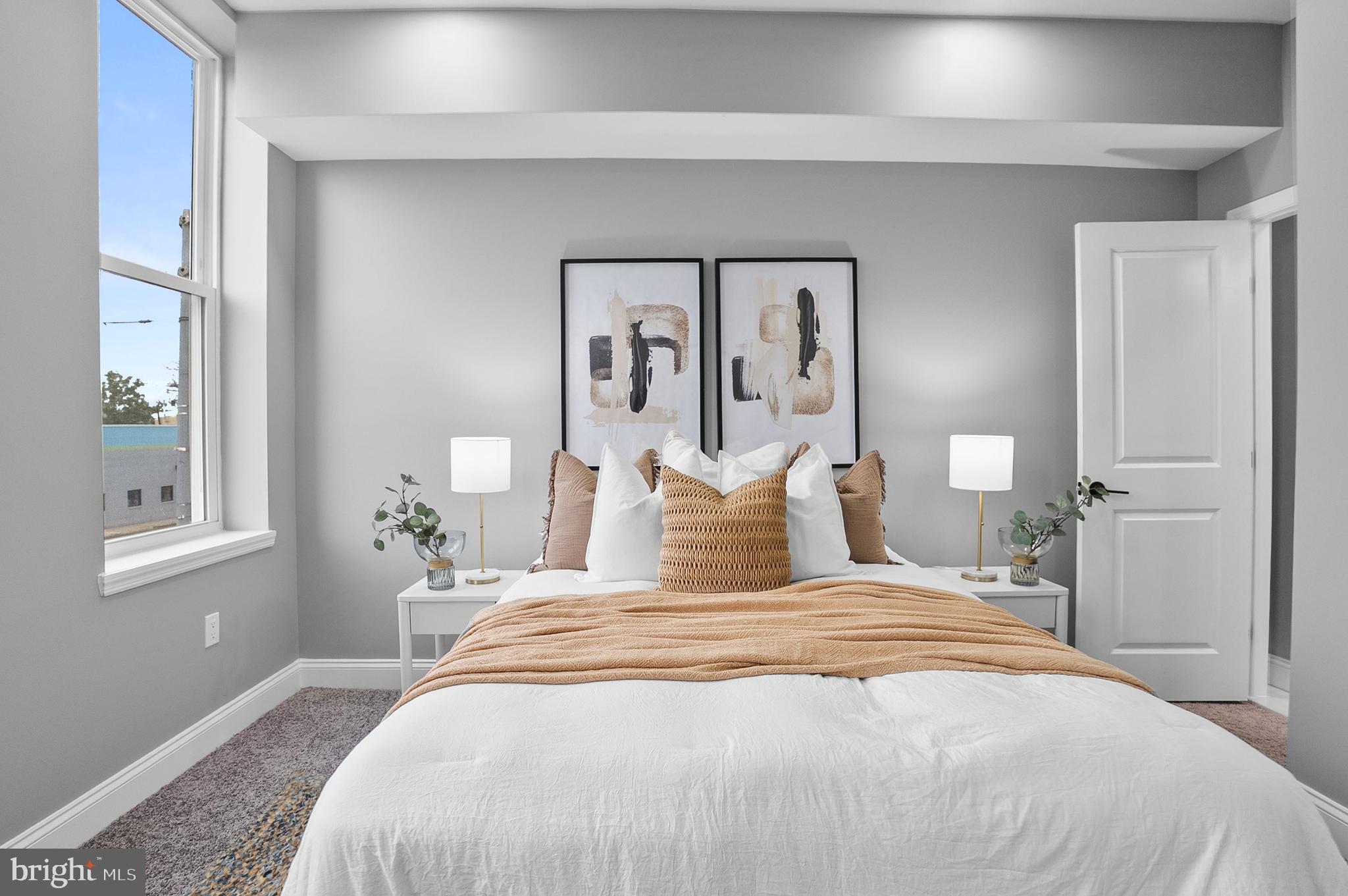 1201 North Fulton Avenue Baltimore, MD 21217 - Photo 6 of 36 a bedroom with a large bed and wooden floor