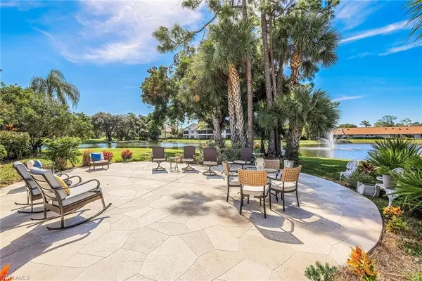 a swimming pool with outdoor seating and yard
