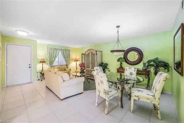 a living room with furniture a rug and white walls