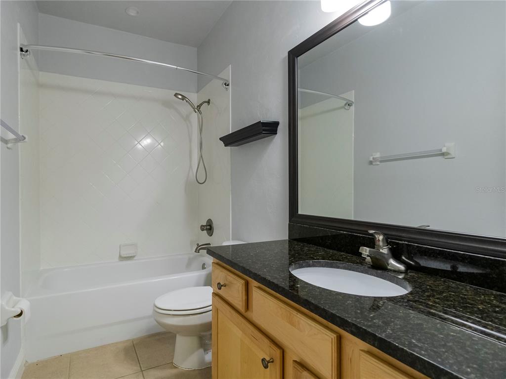 14001 Northwest 9th Road Newberry, FL 32669 - Photo 13 of 17 a bathroom with a granite countertop sink toilet and shower